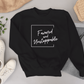 The Favoured & Unstoppable Sweatshirt by AfroBold featuring bold text design, crafted with premium fabric for comfort and cultural pride in modern style.